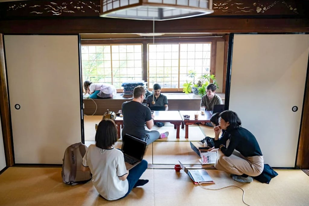 Kyoto Tech Meetup members working together around laptops in a tatami room